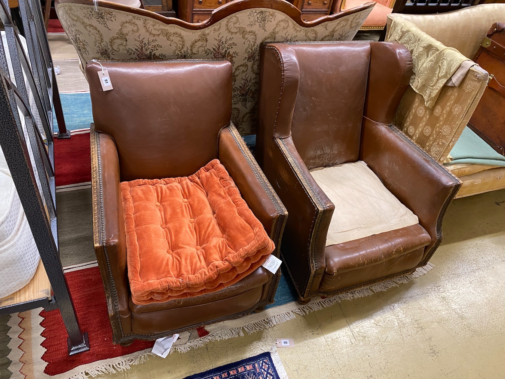 A pair of early 20th century oak tan leatherette armchairs
